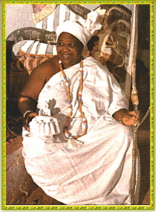 Dignitary shown smiling, sitting in royal wear, from the book Ewe by Ofori Akyea.